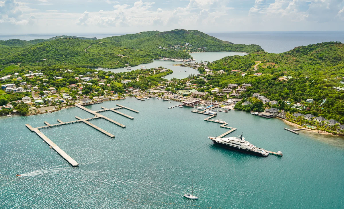 Aerial view of a superyacht berthed at an Antigua marina