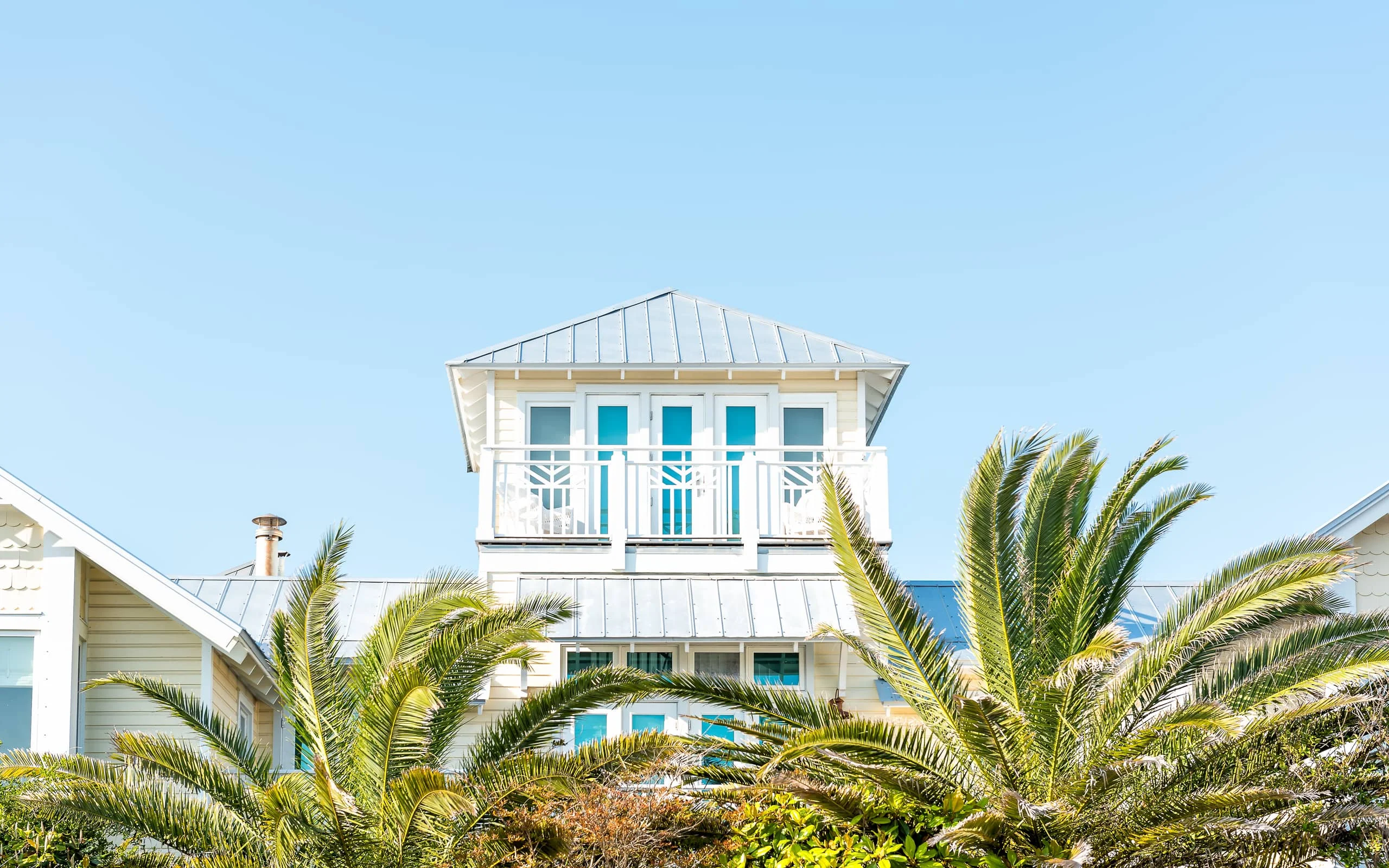 Colonial-style architecture framed by palms in Antigua