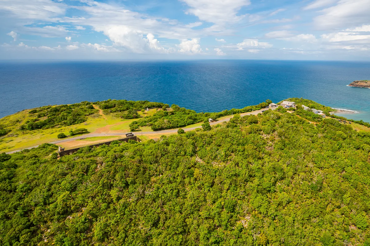 A couple taking in the view over Antigua's coast from a villa lookout