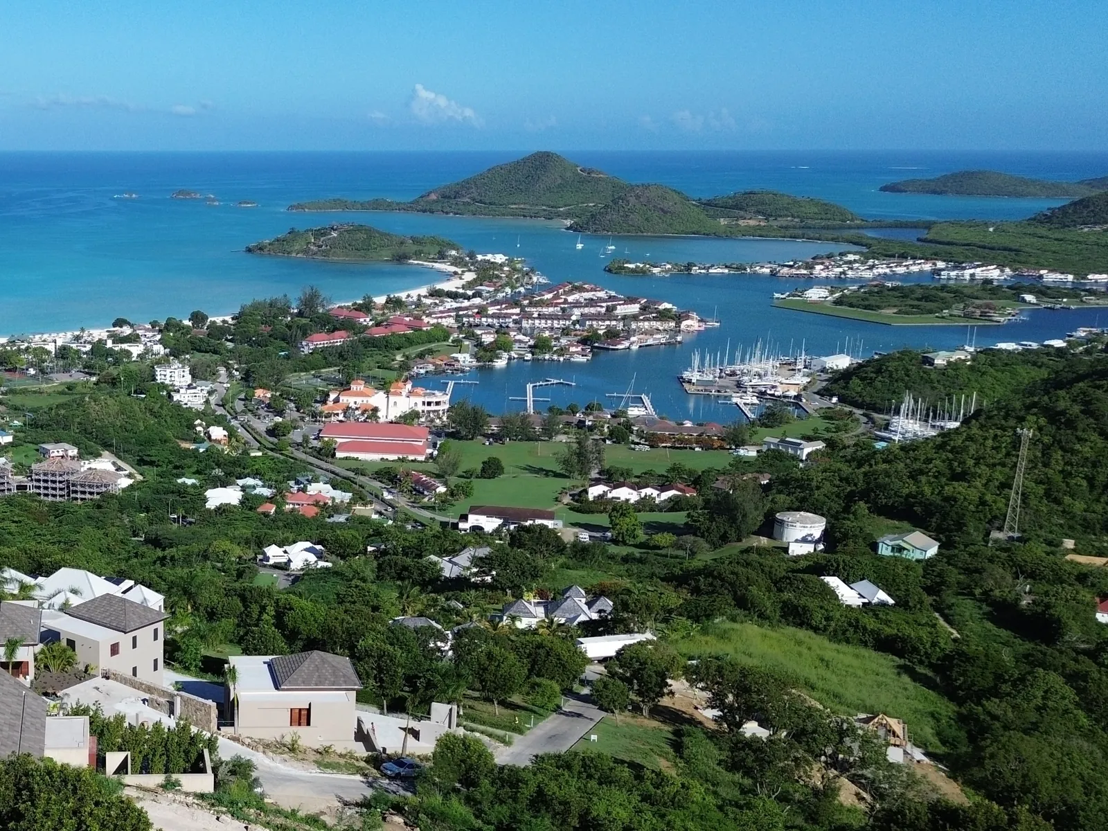 Hillside homes above Jolly Harbour, with the marina and Antigua's west coast beyond