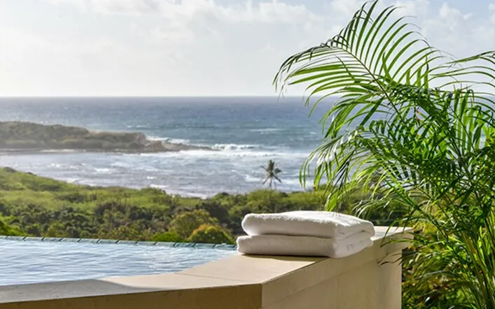 Infinity pool overlooking the Atlantic coastline at Moon Gate Antigua, Half Moon Bay, St. Philip